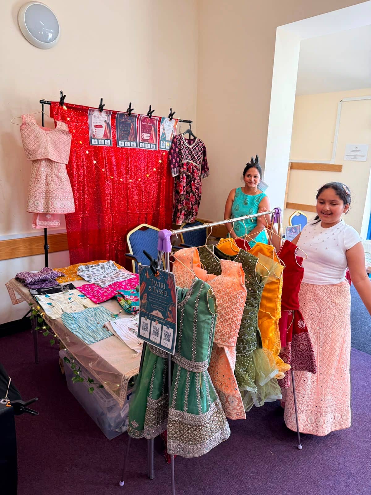 The Twirl and Tassel rail of colourful girls' lehengas at the Shakti mela stall